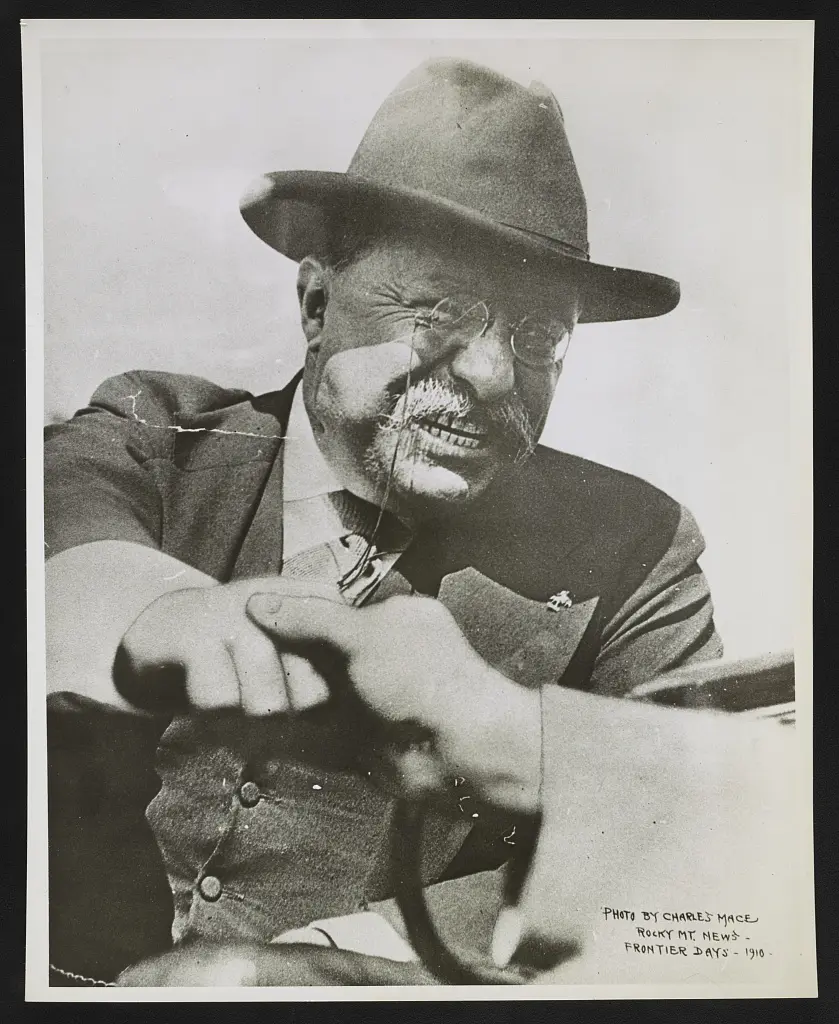 Theodore Roosevelt shaking hands with an unknown person